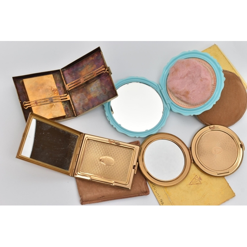 79 - FOUR COMPACTS, to include a boxed 'Kigu' compact, a floral detailed 'Kigu' compact with pouch, a blu... 