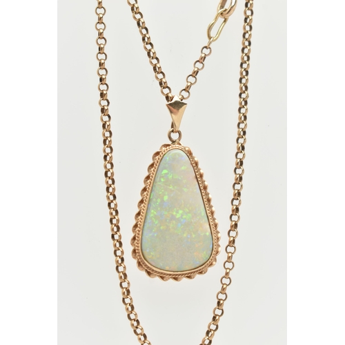 140 - AN OPAL PENDANT AND CHAIN, the triangular opal within a collet and double rope twist surround, suspe... 