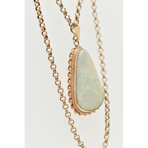 140 - AN OPAL PENDANT AND CHAIN, the triangular opal within a collet and double rope twist surround, suspe... 