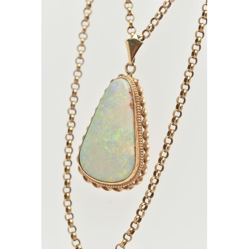 140 - AN OPAL PENDANT AND CHAIN, the triangular opal within a collet and double rope twist surround, suspe... 