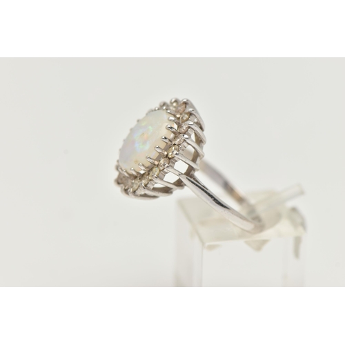 141 - AN OPAL AND DIAMOND CLUSTER RING, designed as a central oval opal cabochon within a single cut diamo... 