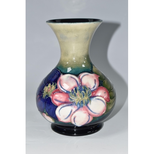 352 - A MOORCROFT POTTERY CLEMATIS VASE, the flared necked vase in 'Clematis' pattern on a graduated green... 