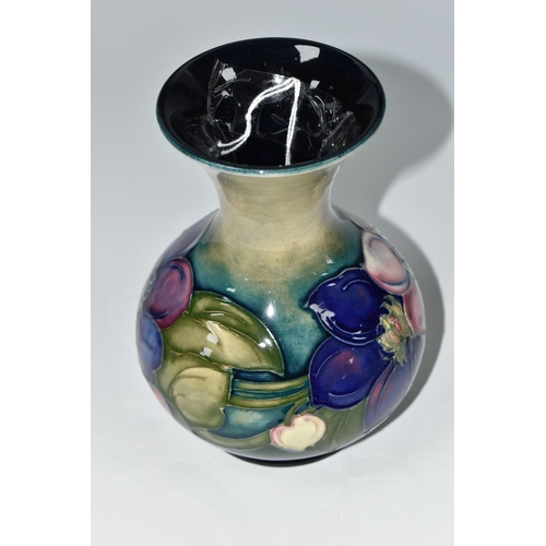 352 - A MOORCROFT POTTERY CLEMATIS VASE, the flared necked vase in 'Clematis' pattern on a graduated green... 