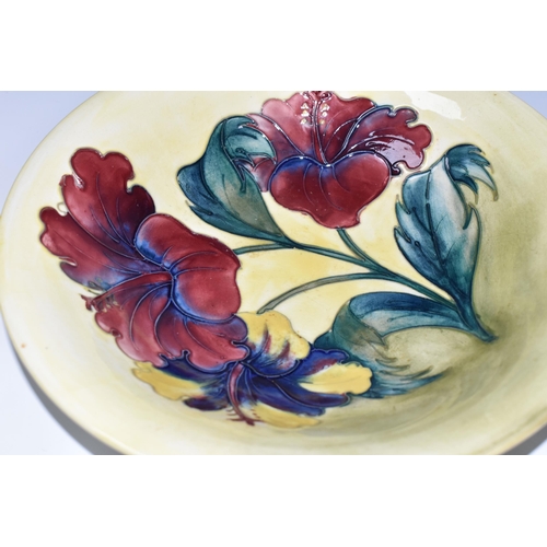 353 - A MOORCROFT POTTERY HIBISCUS VASE, the footed bowl in 'Hibiscus' pattern on a yellow green ground, p... 