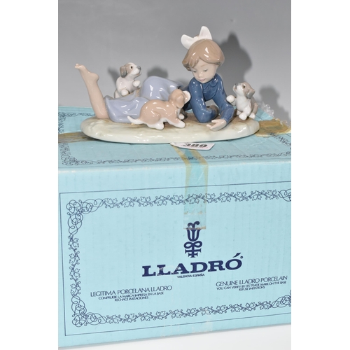 389 - A BOXED LLADRO 'PLAYFUL ROMP' FIGURE, depicting a girl with three puppies, model no 5594, sculptor F... 