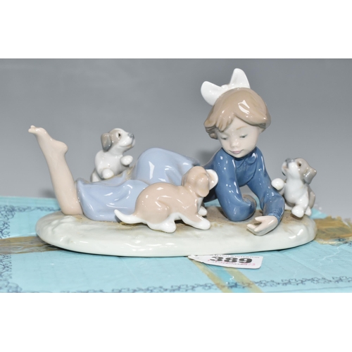 389 - A BOXED LLADRO 'PLAYFUL ROMP' FIGURE, depicting a girl with three puppies, model no 5594, sculptor F... 