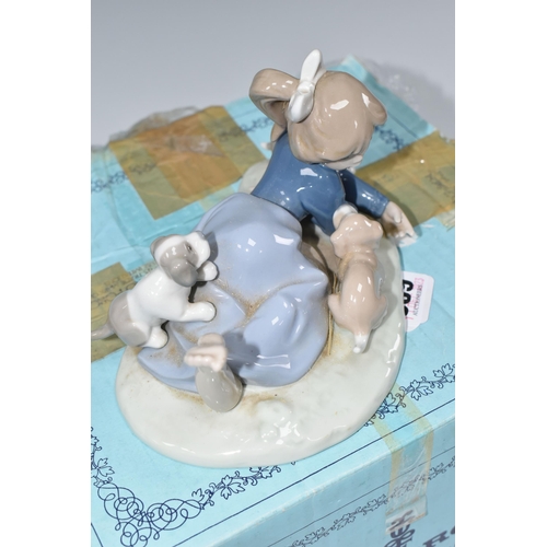 389 - A BOXED LLADRO 'PLAYFUL ROMP' FIGURE, depicting a girl with three puppies, model no 5594, sculptor F... 