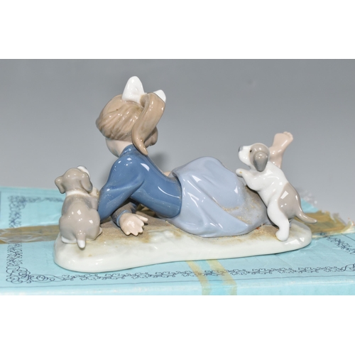 389 - A BOXED LLADRO 'PLAYFUL ROMP' FIGURE, depicting a girl with three puppies, model no 5594, sculptor F... 