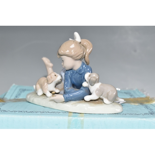 389 - A BOXED LLADRO 'PLAYFUL ROMP' FIGURE, depicting a girl with three puppies, model no 5594, sculptor F... 