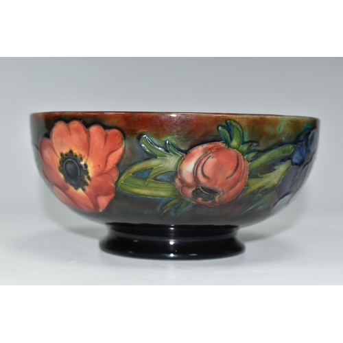 403 - A MOORCROFT POTTERY FLAMBÉ BOWL, the footed bowl in the Anemone pattern on a red/green/blue ground, ... 