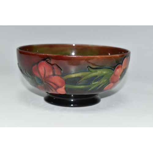 403 - A MOORCROFT POTTERY FLAMBÉ BOWL, the footed bowl in the Anemone pattern on a red/green/blue ground, ... 