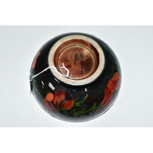 403 - A MOORCROFT POTTERY FLAMBÉ BOWL, the footed bowl in the Anemone pattern on a red/green/blue ground, ... 