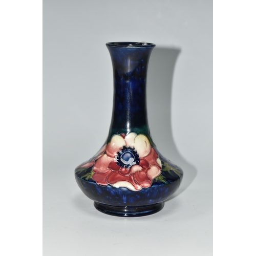 404 - A MOORCROFT POTTERY VASE, tube lined in Anemone pattern on a cobalt blue ground, impressed and paint... 