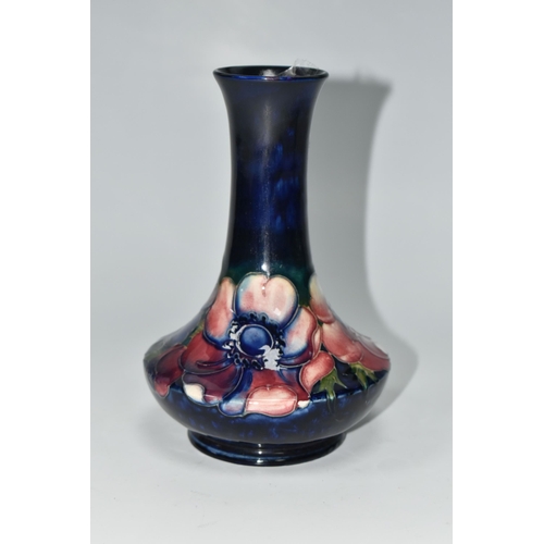 404 - A MOORCROFT POTTERY VASE, tube lined in Anemone pattern on a cobalt blue ground, impressed and paint... 