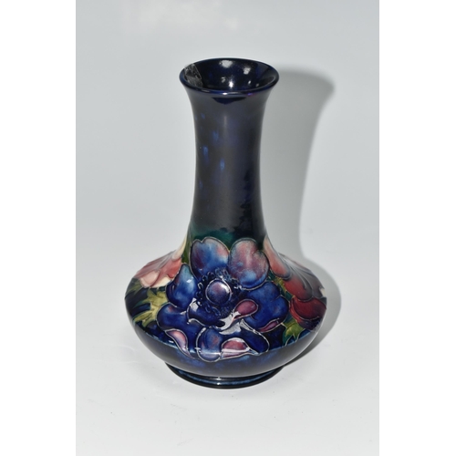 404 - A MOORCROFT POTTERY VASE, tube lined in Anemone pattern on a cobalt blue ground, impressed and paint... 