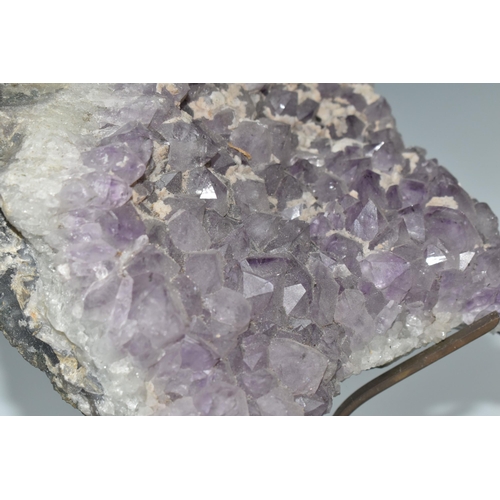 430 - AN AMETHYST CRYSTAL CLUSTER GEODE, supported by a metal display stand with original Harrod's store l... 