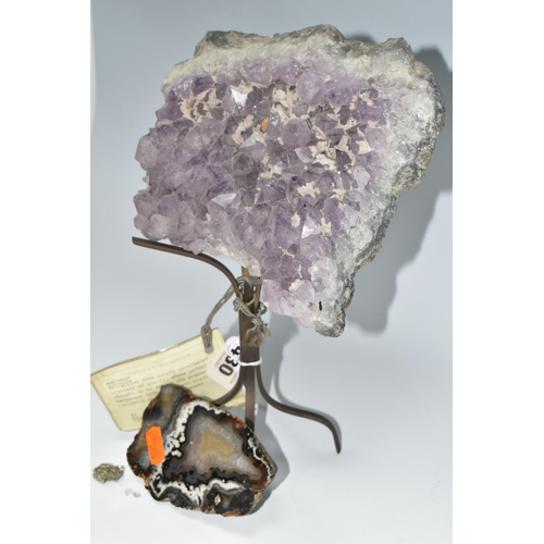 430 - AN AMETHYST CRYSTAL CLUSTER GEODE, supported by a metal display stand with original Harrod's store l... 