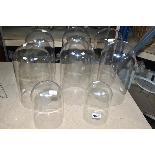 453 - EIGHT GLASS AND PERSPEX DOMES, comprising four glass domes, ranging in height from 14.5cm to 26cm, d... 