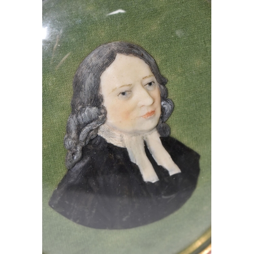 472 - A MOULDED WAX PORTRAIT BUST OF REV. JOHN WESLEY, mounted on green velvet and in an oval gilt frame, ... 