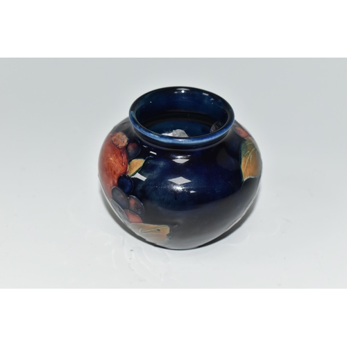 476 - A MOORCROFT POTTERY POMEGRANATE VASE, of squat form, tube lined in Pomegranate pattern on a deep blu... 