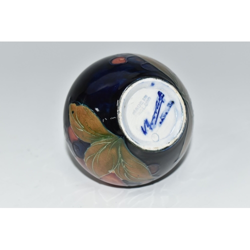 476 - A MOORCROFT POTTERY POMEGRANATE VASE, of squat form, tube lined in Pomegranate pattern on a deep blu... 