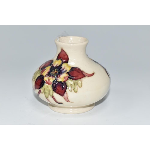 484 - A MOORCROFT POTTERY SQUAT COLUMBINE VASE, tube lined with purple, red and yellow columbine flowers o... 