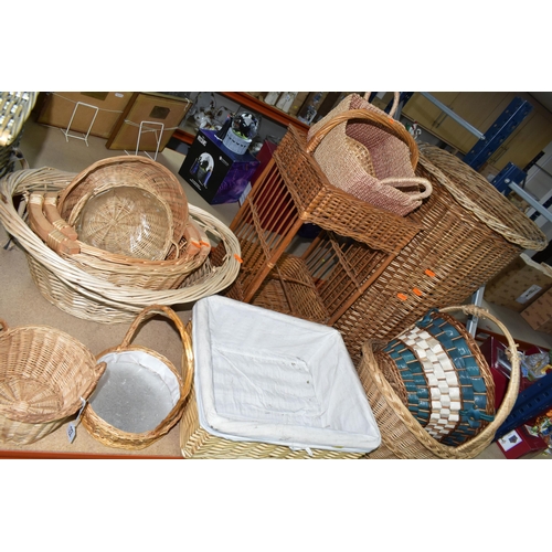 515 - A COLLECTION OF WICKER BASKETS, to include laundry baskets, hamper, a two tier stand, baskets with a... 