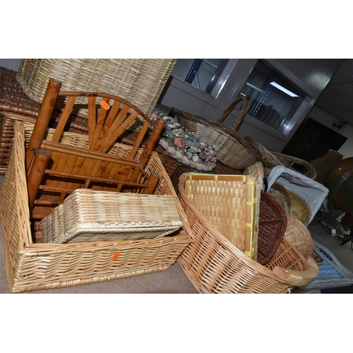 562 - A LARGE QUANTITY OF WICKER BASKETS, comprising linen baskets, serving tray, letter rack, flower bask... 