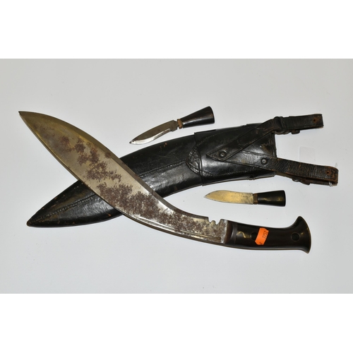 291 - A NEPALESE GURKHA KUKRI KNIFE, in its leather scabbard complete with its Kardar and Chakma knives