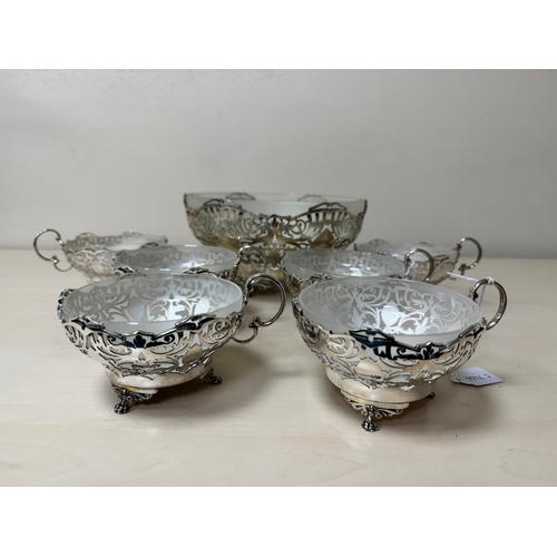 114 - A GEORGE VI SILVER AND FROSTED GLASS LINED DESSERT SET, comprising a fruit bowl and six dishes, each... 