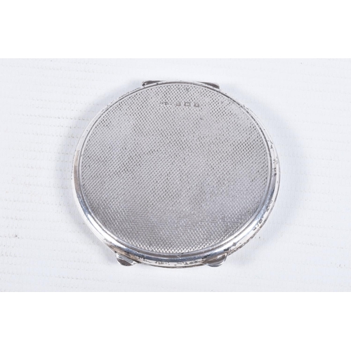 105 - A SILVER COMPACT, of circular outline with engine turned decoration and central banded detail with e... 