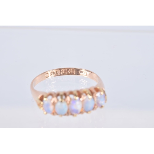 12 - A LATE VICTORIAN 15CT GOLD OPAL RING, designed as a row of five oval cut opals, each claw set to a p... 