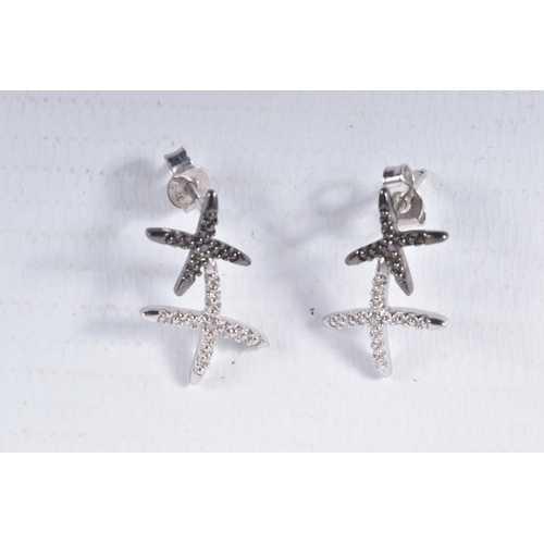 13 - A PAIR OF 9CT GOLD DIAMOND SET EARRINGS, each designed as two crosses set with single cut black and ... 