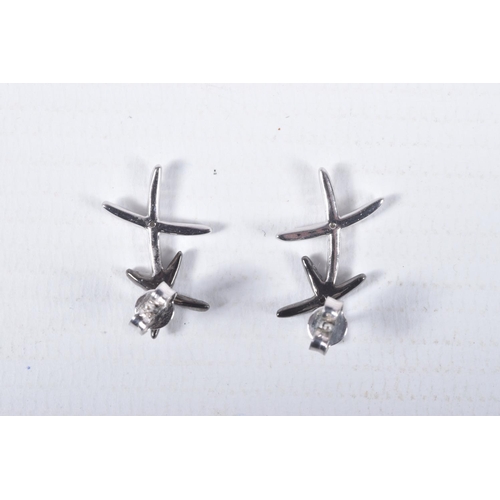 13 - A PAIR OF 9CT GOLD DIAMOND SET EARRINGS, each designed as two crosses set with single cut black and ... 