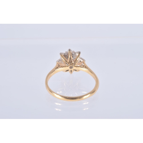 25 - A DIAMOND CLUSTER RING, the central brilliant cut diamond in a star setting within a tiered single c... 