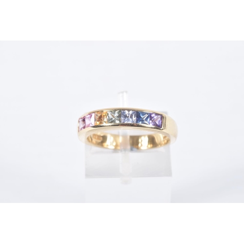 27 - AN 18CT GOLD MULTI GEM RING, set with seven square cut gems in a channel setting, including sapphire... 