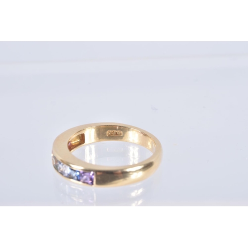 27 - AN 18CT GOLD MULTI GEM RING, set with seven square cut gems in a channel setting, including sapphire... 