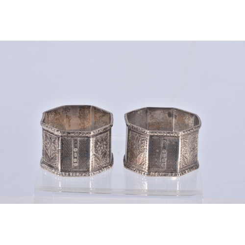 30 - A PAIR OF LATE VICTORIAN SILVER OCTAGONAL NAPKIN RINGS, alternate engine turned and engraved panels,... 