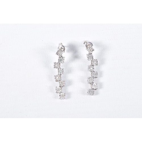 33 - A PAIR OF 9CT WHITE GOLD DIAMOND DROP EARRINGS, each earring set with a row of illusion set round br... 