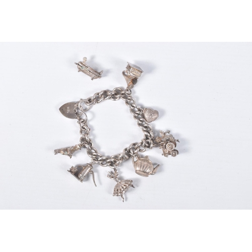 35 - A SMALL BAG OF ASSORTED WHITE METAL JEWELLERY, to include a silver charm bracelet fitted with eight ... 