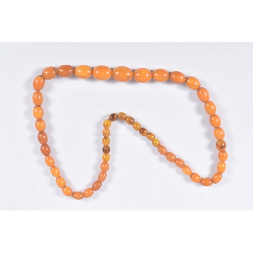 36 - AN AMBER BEAD NECKLACE, designed as a single row of graduating oval beads, largest bead measuring ap... 