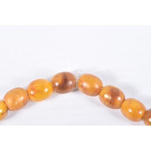 36 - AN AMBER BEAD NECKLACE, designed as a single row of graduating oval beads, largest bead measuring ap... 