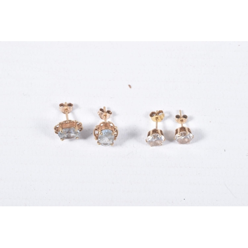 43 - TWO PAIRS OF EAR STUDS, the first designed as an oval blue topaz within a four claw setting with a s... 