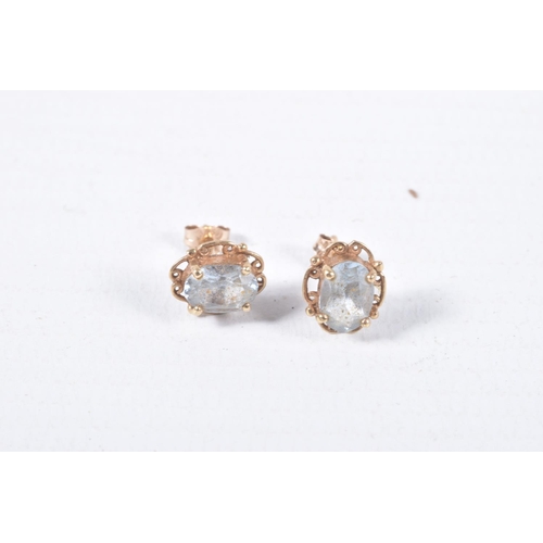 43 - TWO PAIRS OF EAR STUDS, the first designed as an oval blue topaz within a four claw setting with a s... 