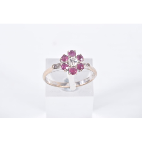 6 - A YELLOW METAL, DIAMOND AND RUBY CLUSTER RING, flower cluster set with a central round brilliant cut... 