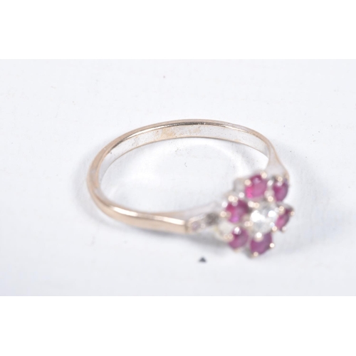 6 - A YELLOW METAL, DIAMOND AND RUBY CLUSTER RING, flower cluster set with a central round brilliant cut... 