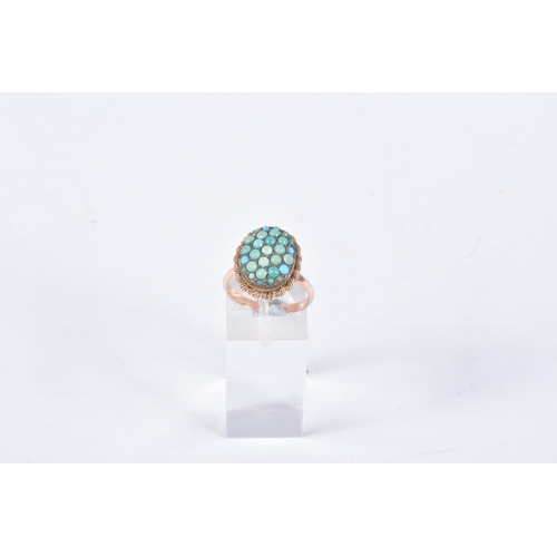 62 - A TURQUOISE RING, the oval panel set with circular turquoise cabochons, some replacements, to the ro... 