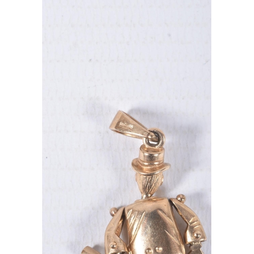 68 - A 9CT GOLD ARTICULATED MAN PENDANT, gentlemen holding a bottle with top hat on, set with blue paste ... 