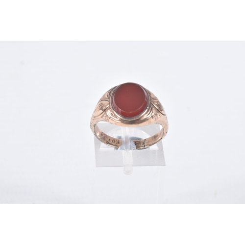 89 - A GENTS SIGNET RING, of an oval form, set with an oval carnelian panel, collet set to the textured s... 