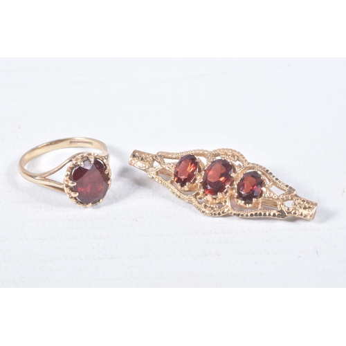 97 - A 9CT GOLD RING AND YELLOW METAL BROOCH, an oval cut garnet, prong set in yellow gold leading on to ... 